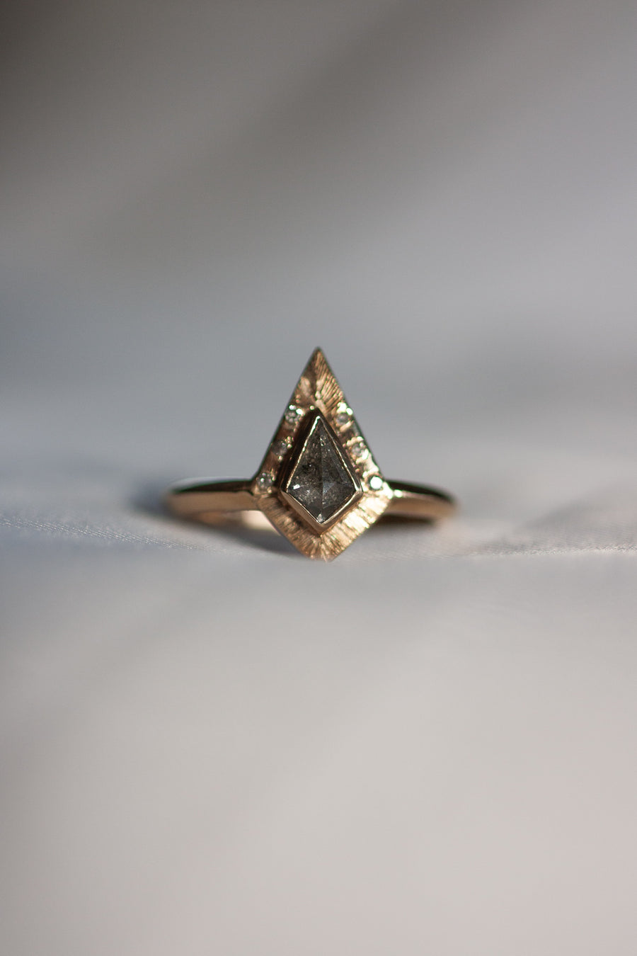 The Endy engagement ring features a stunning kite shaped diamond and intricate hand engraving.