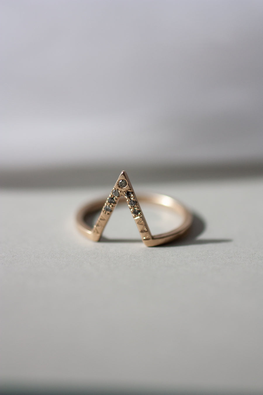 Fine alternative jewelry in East Kootenays: Acre wedding band with kite shape diamonds and hand engraved triangle details